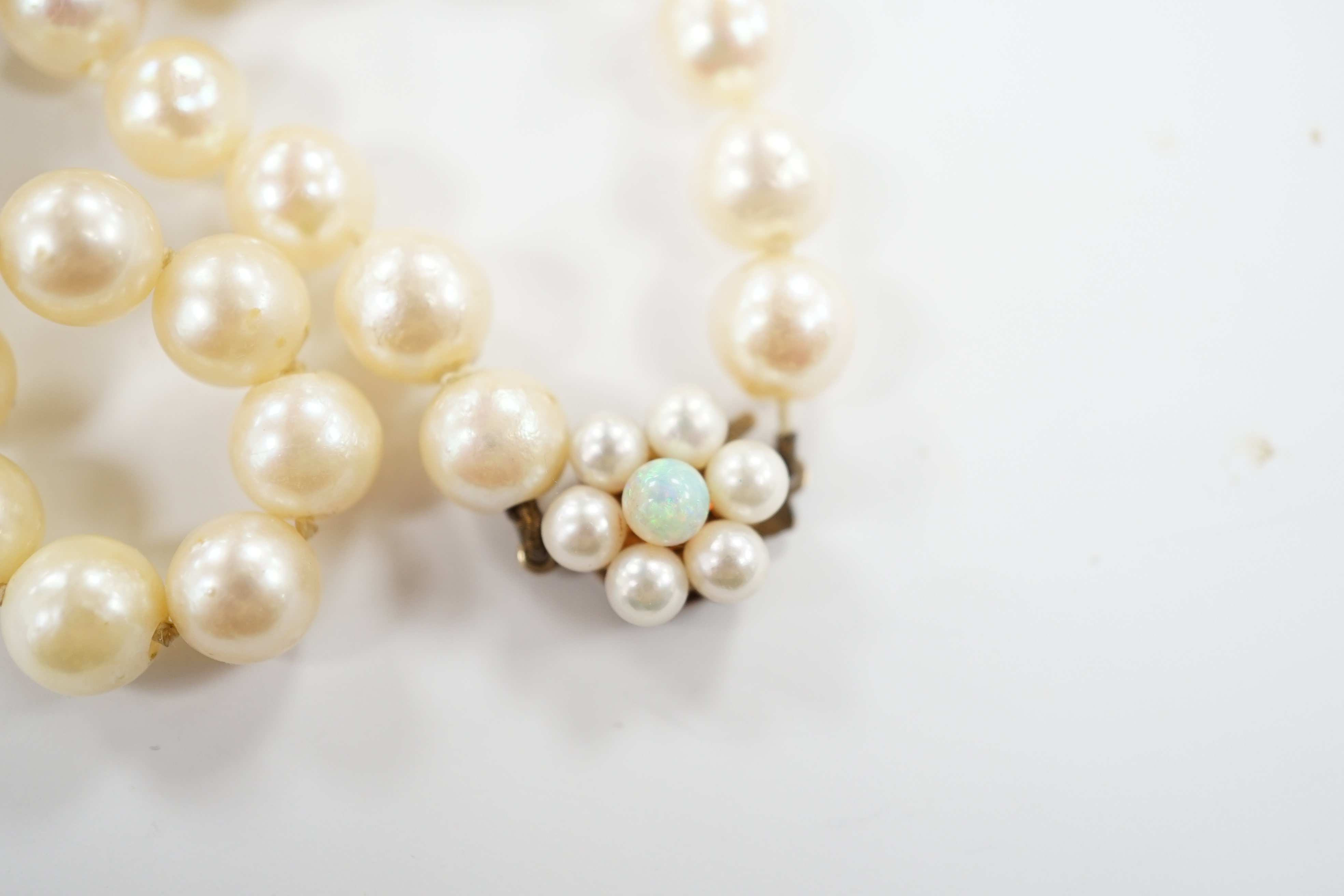 Two single strand cultured pearl necklaces, one with 9ct, white opal and cultured pearl set clasp, 40cm and a cloisonné bangle.